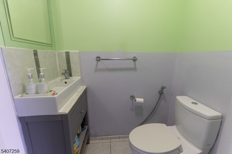 614 West 8th Street, Unit 15 Plainfield, NJ 07060 - Photo 13 of 28 a white toilet sitting next to a white sink and vanity