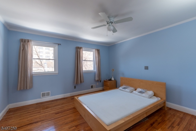 614 West 8th Street, Unit 15 Plainfield, NJ 07060 - Photo 14 of 28 a bed sitting in a spacious bedroom next to a window