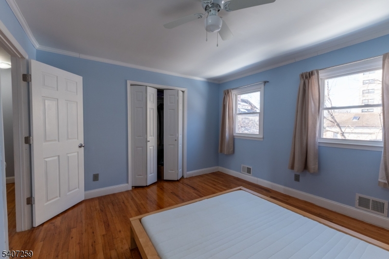 614 West 8th Street, Unit 15 Plainfield, NJ 07060 - Photo 15 of 28 a bedroom with window and a wooden floor
