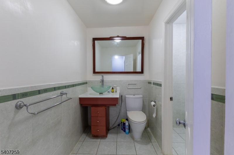 614 West 8th Street, Unit 15 Plainfield, NJ 07060 - Photo 17 of 28 a bathroom with a toilet sink and mirror