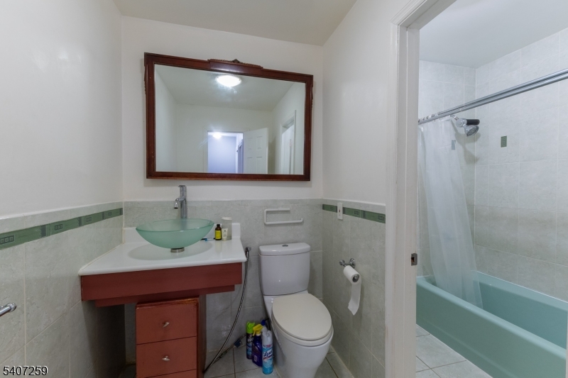 614 West 8th Street, Unit 15 Plainfield, NJ 07060 - Photo 18 of 28 a bathroom with a toilet sink and mirror