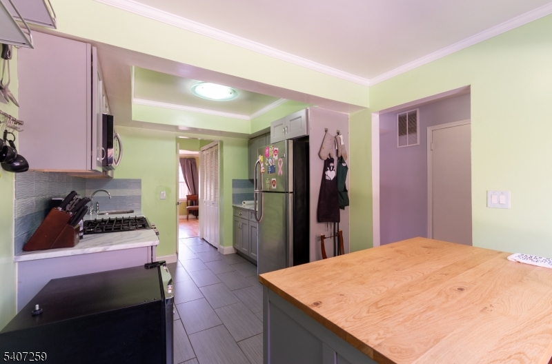 614 West 8th Street, Unit 15 Plainfield, NJ 07060 - Photo 9 of 28 a kitchen with stainless steel appliances kitchen island sink refrigerator and stove