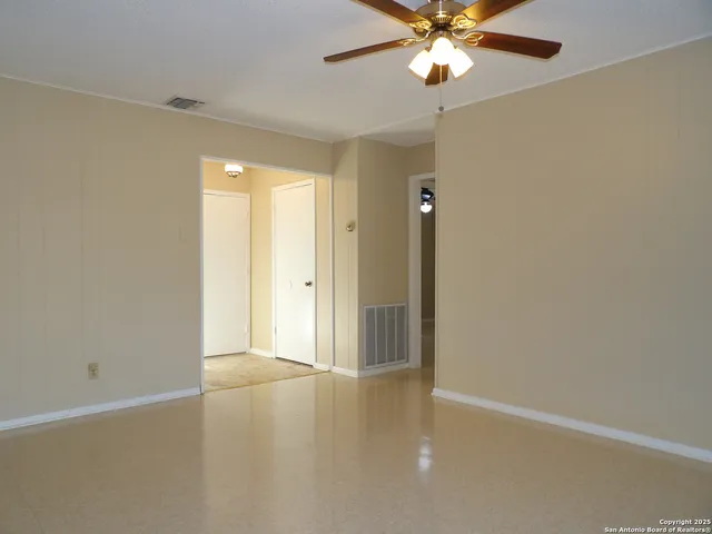 a view of a livingroom with a chandelier fan