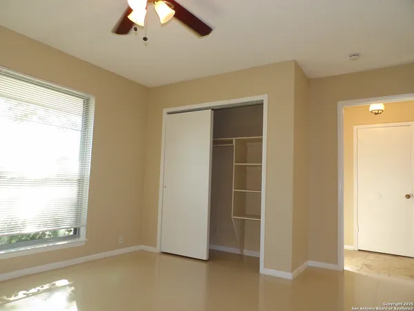 a view of room with window and ceiling fan