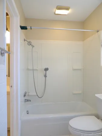 a bathroom with a toilet and a shower