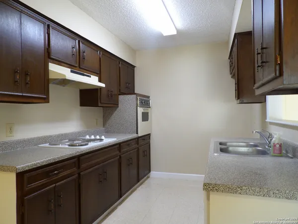 a kitchen with stainless steel appliances granite countertop a sink stove and cabinets