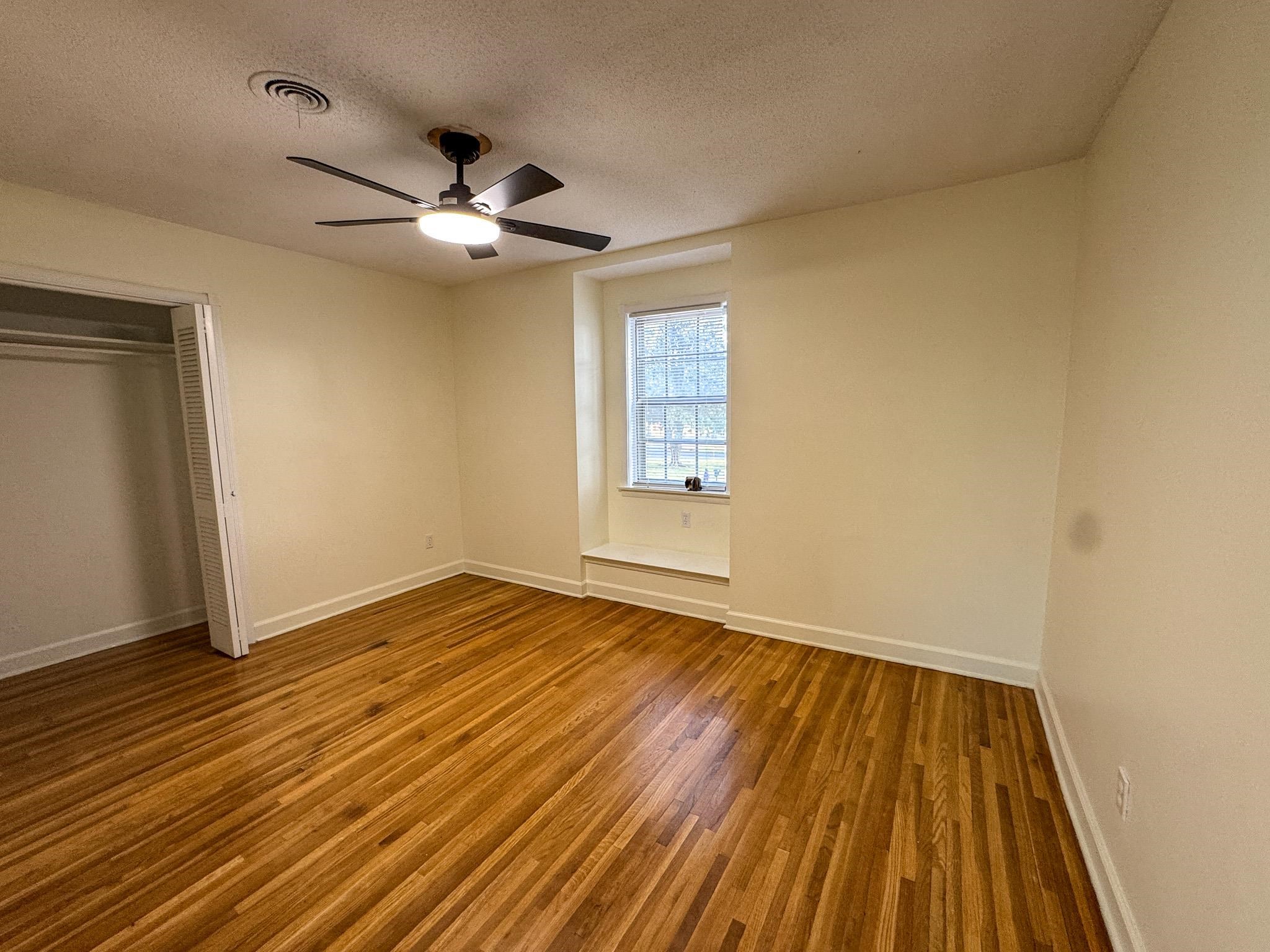 1345 Hickory Ridge Cove Memphis, TN 38116 - Photo 8 of 29 a view of empty room with wooden floor and fan