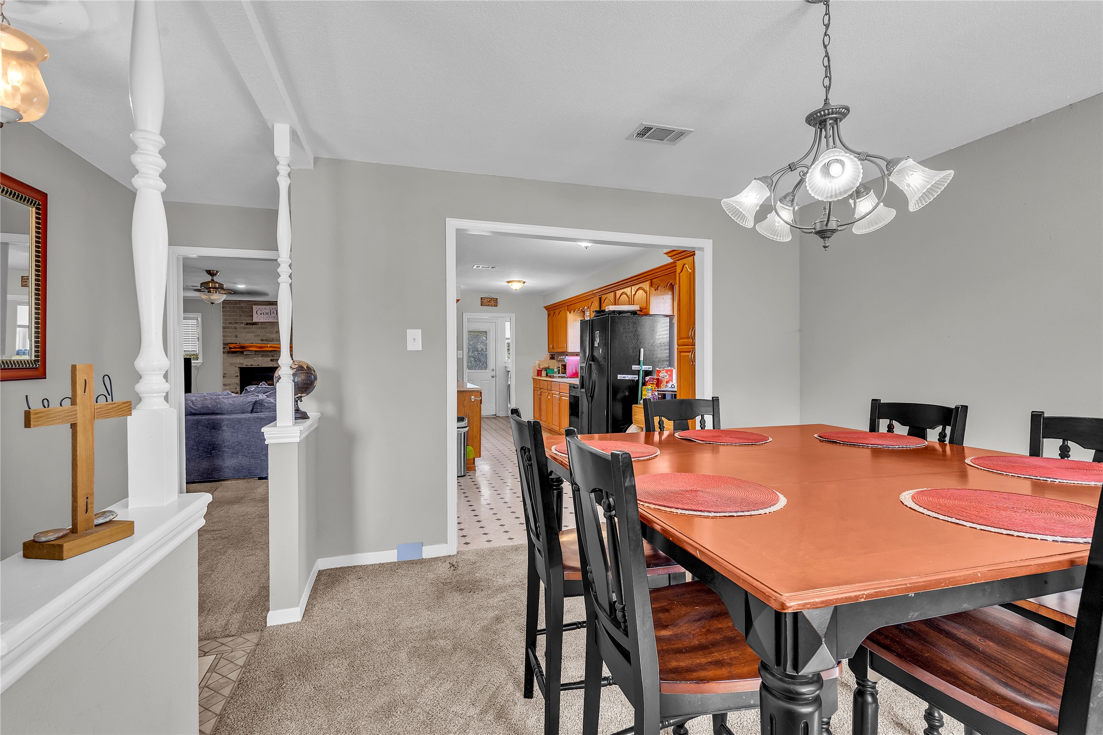 An open doorway connects the carpeted dining area directly to the kitchen.