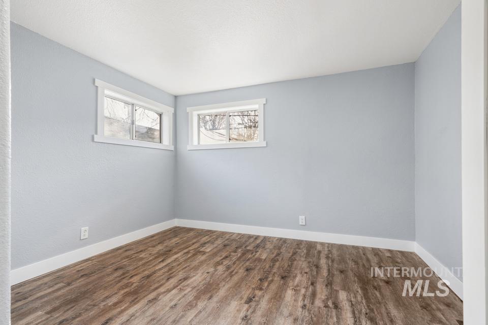 253 West Court Street Weiser, ID 83672 - Photo 18 of 35 Spare room featuring wood finished floors and baseboards