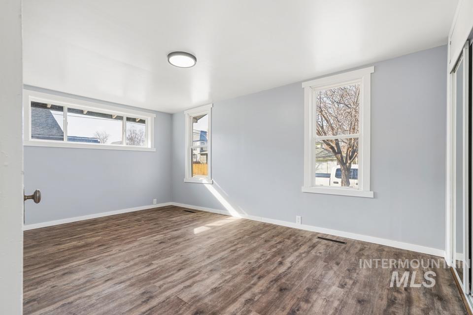253 West Court Street Weiser, ID 83672 - Photo 20 of 35 Unfurnished room featuring baseboards and dark wood finished floors