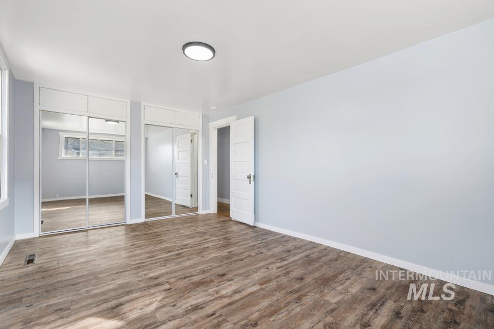 253 West Court Street Weiser, ID 83672 - Photo 21 of 35 Unfurnished bedroom with two closets and wood finished floors