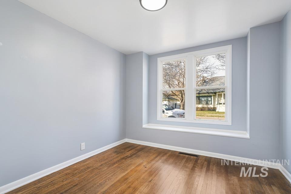 253 West Court Street Weiser, ID 83672 - Photo 25 of 35 Empty room featuring dark wood-style floors and baseboards