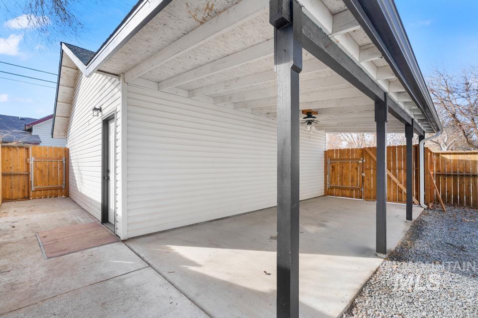 253 West Court Street Weiser, ID 83672 - Photo 29 of 35 Fenced backyard with a gate, ceiling fan, and a patio