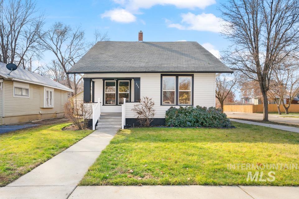253 West Court Street Weiser, ID 83672 - Photo 34 of 35 View of front of house featuring a front yard, a chimney, and roof with shingles