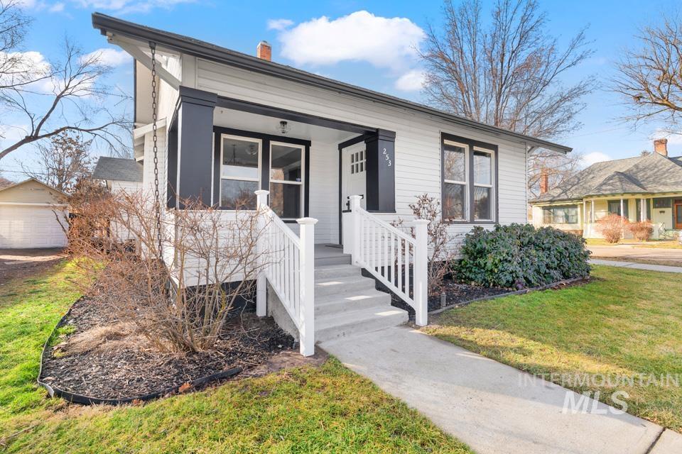 253 West Court Street Weiser, ID 83672 - Photo 35 of 35 View of front of house with a chimney, a front lawn, a porch, and a garage