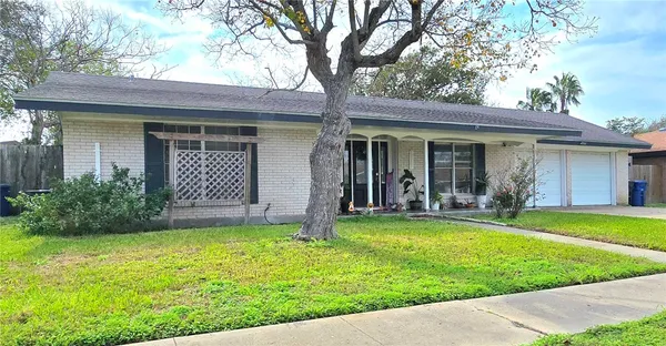a view of a house with a yard and porch