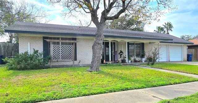 a view of a house with a yard and porch