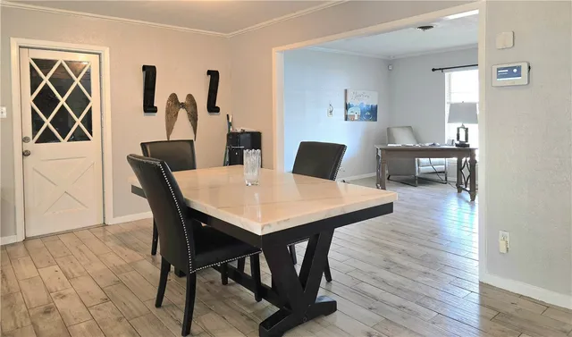 a view of a dining room with furniture and wooden floor