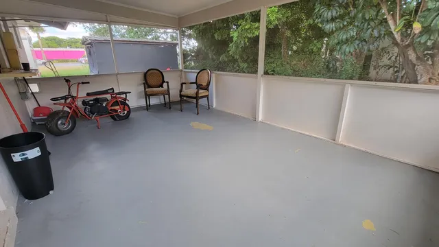 a living room with furniture a flat screen tv and a floor to ceiling window
