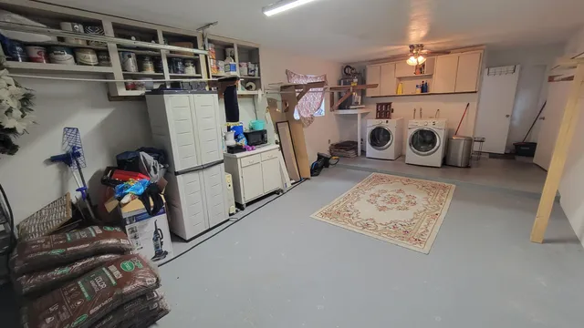 a view of storage and utility room with washer and dryer