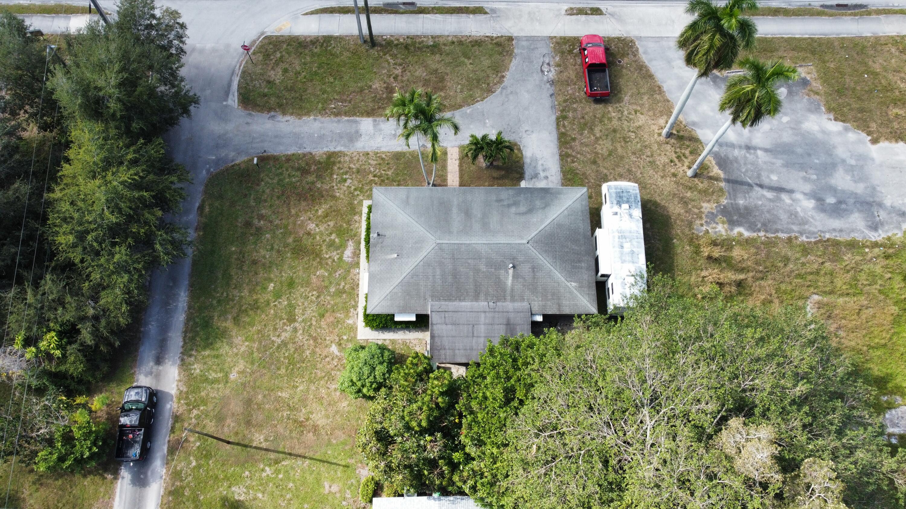 3340 Jog Road Greenacres, FL 33467 - Photo 3 of 20 an aerial view of a house with a yard and large trees