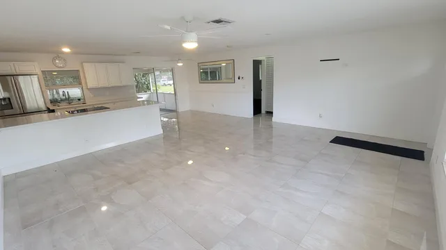 a view of a kitchen with refrigerator and a counter top