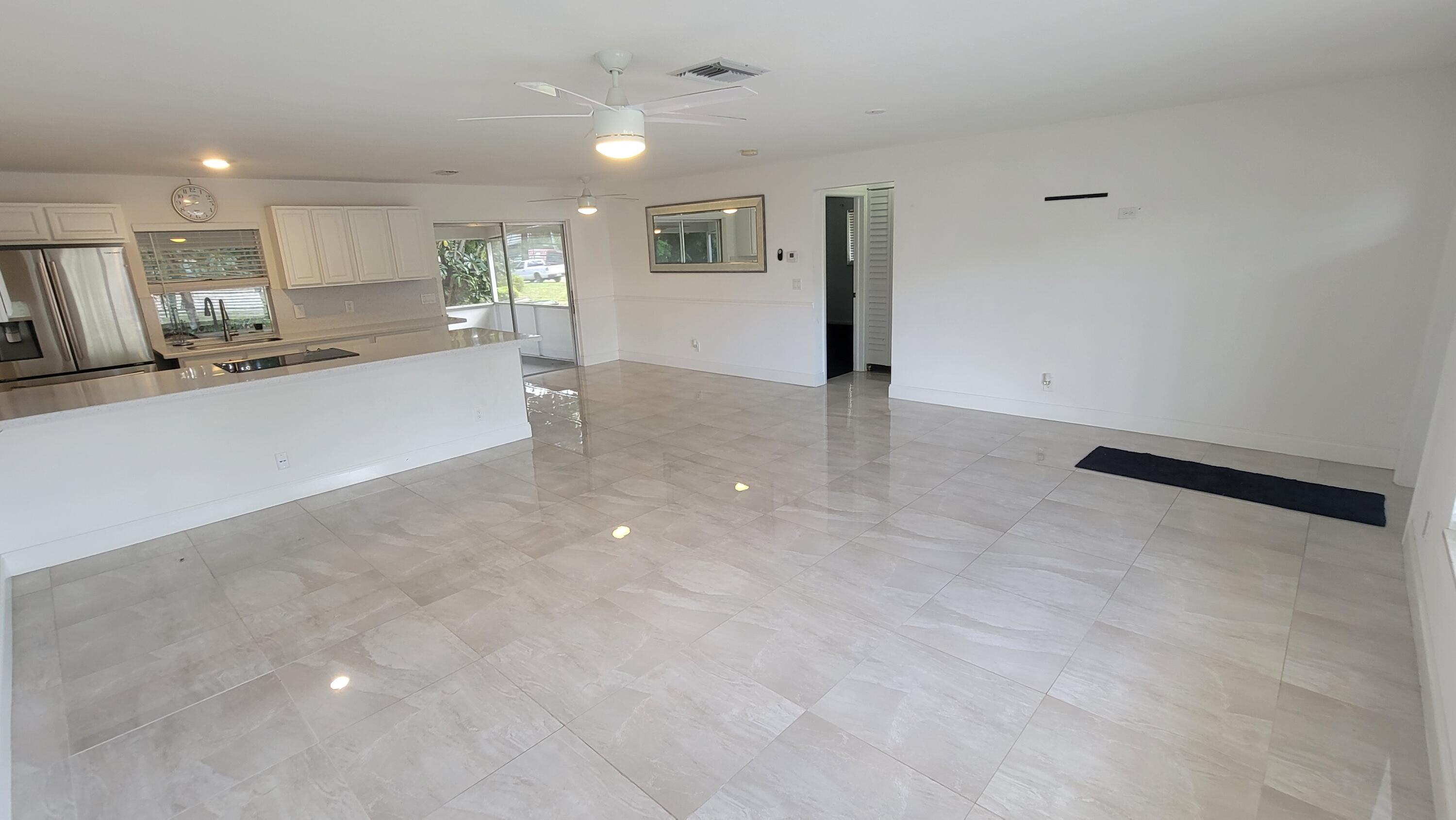 3340 Jog Road Greenacres, FL 33467 - Photo 7 of 20 a view of a kitchen with refrigerator and a counter top