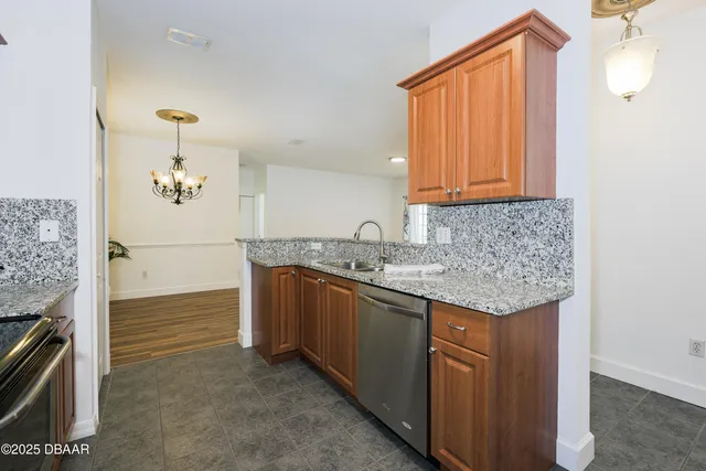 a kitchen with granite countertop a sink and a stove