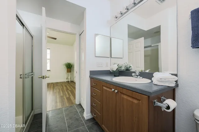a bathroom with a granite countertop sink and a mirror