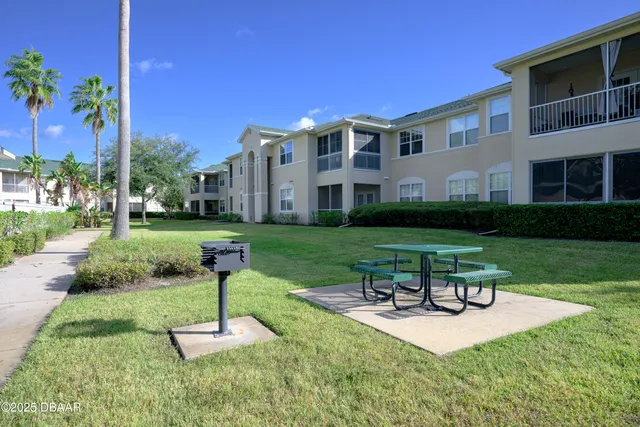a swimming pool with outdoor seating and yard