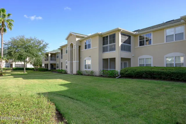a front view of building with yard