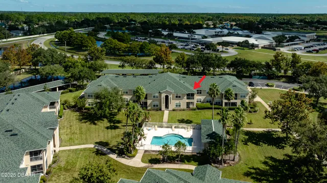 an aerial view of residential houses with outdoor space and swimming pool
