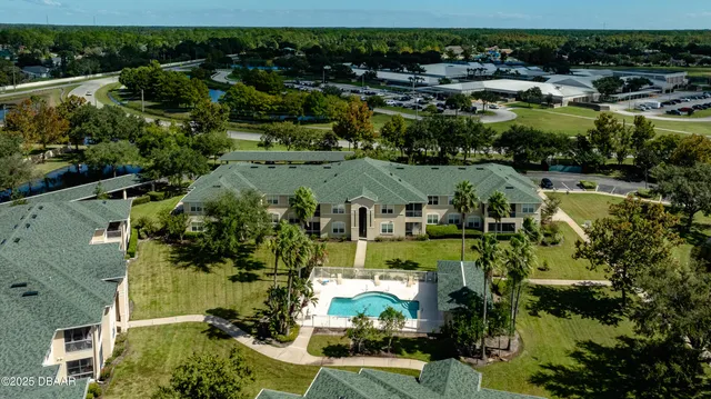 an aerial view of residential houses with outdoor space and parking space