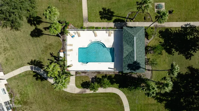 an aerial view of a house with a yard
