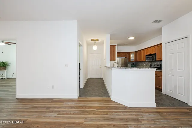 a view of kitchen and kitchen with stainless steel appliances