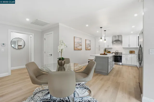 a living room with stainless steel appliances kitchen island granite countertop furniture and wooden floor