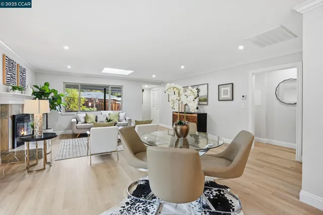 a living room with furniture a fireplace and a table