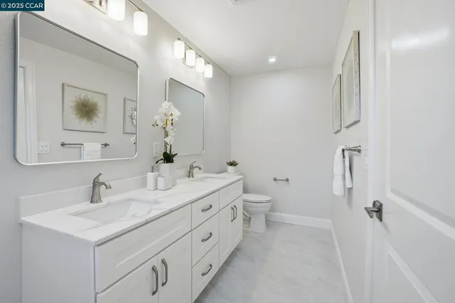 a bathroom with a double vanity sink and mirror