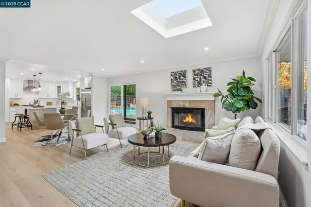 a living room with furniture a fireplace and a large window