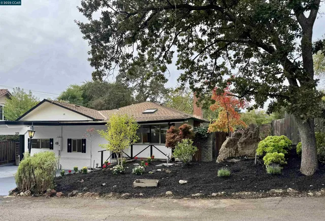 a front view of a house with garden