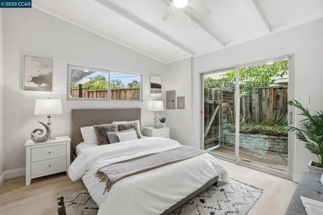 a bedroom with furniture and a large window
