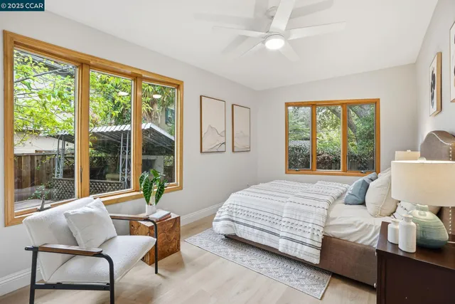 a bedroom with a bed and a large window