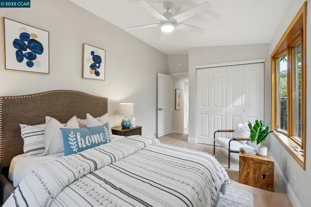 a spacious bedroom with a large bed and a chandelier