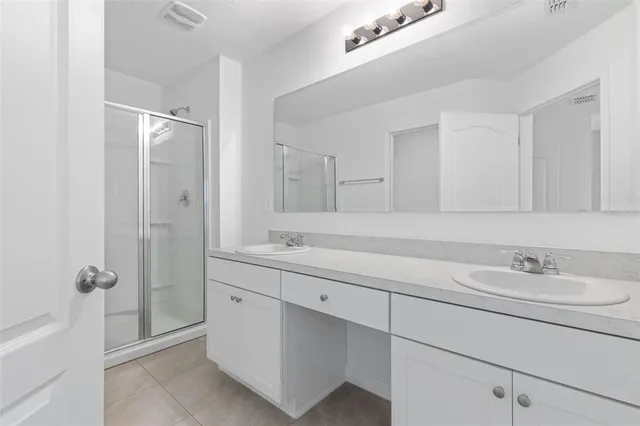 a bathroom with a double vanity sink mirror and