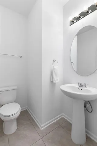 a bathroom with a sink a toilet and mirror