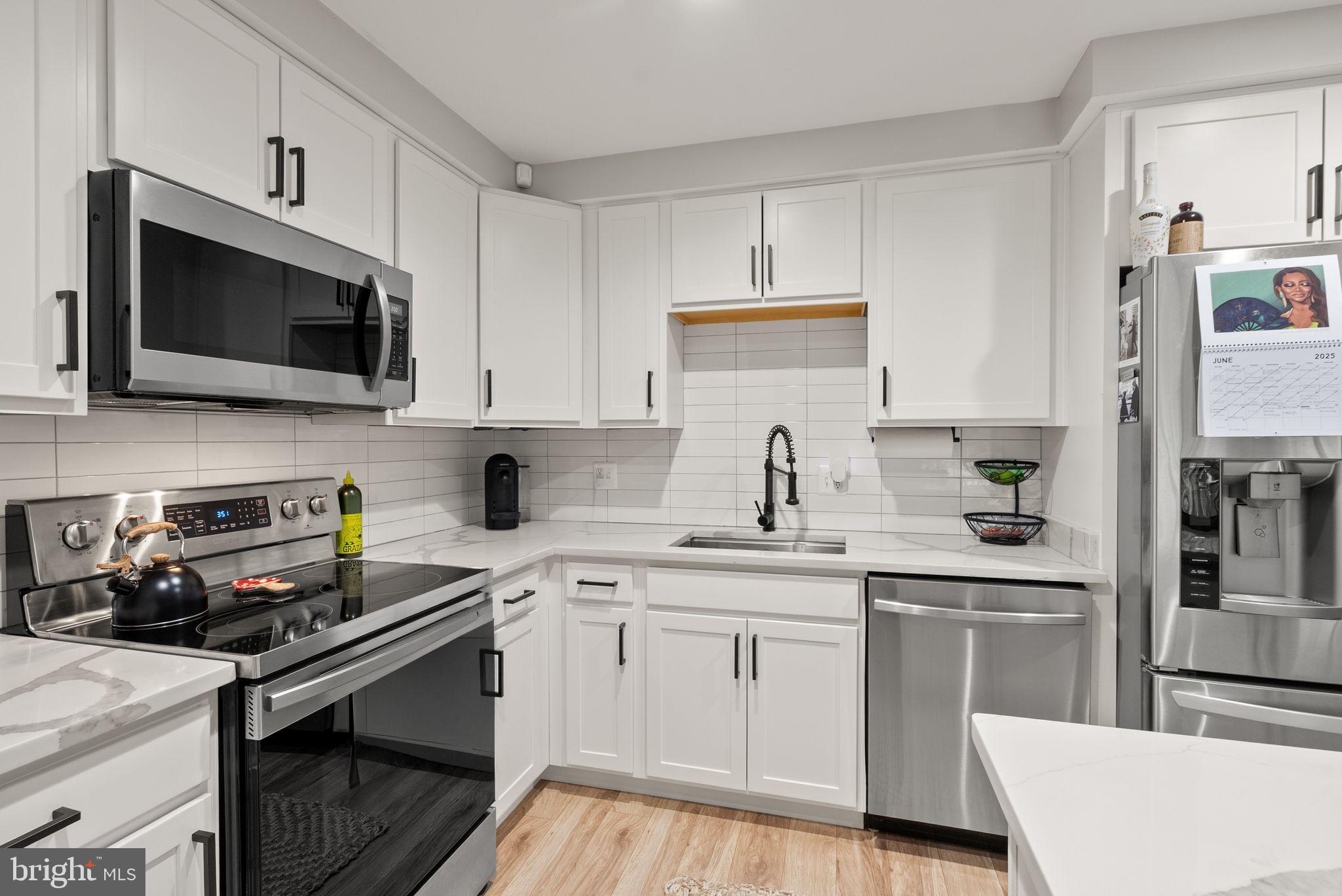 6137 Edsall Road, Unit L Alexandria, VA 22304 - Photo 16 of 36 a kitchen with a sink stove and microwave