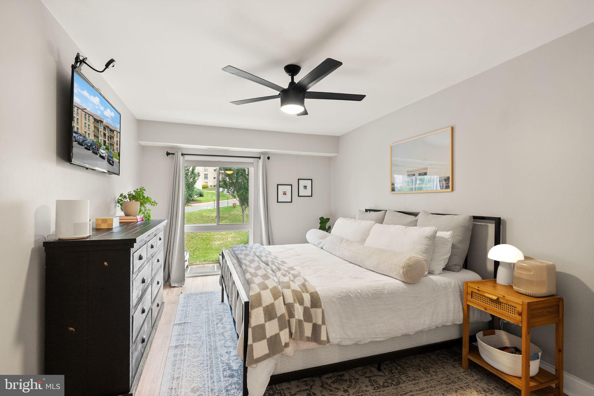 6137 Edsall Road, Unit L Alexandria, VA 22304 - Photo 24 of 36 a spacious bedroom with a bed and a chandelier