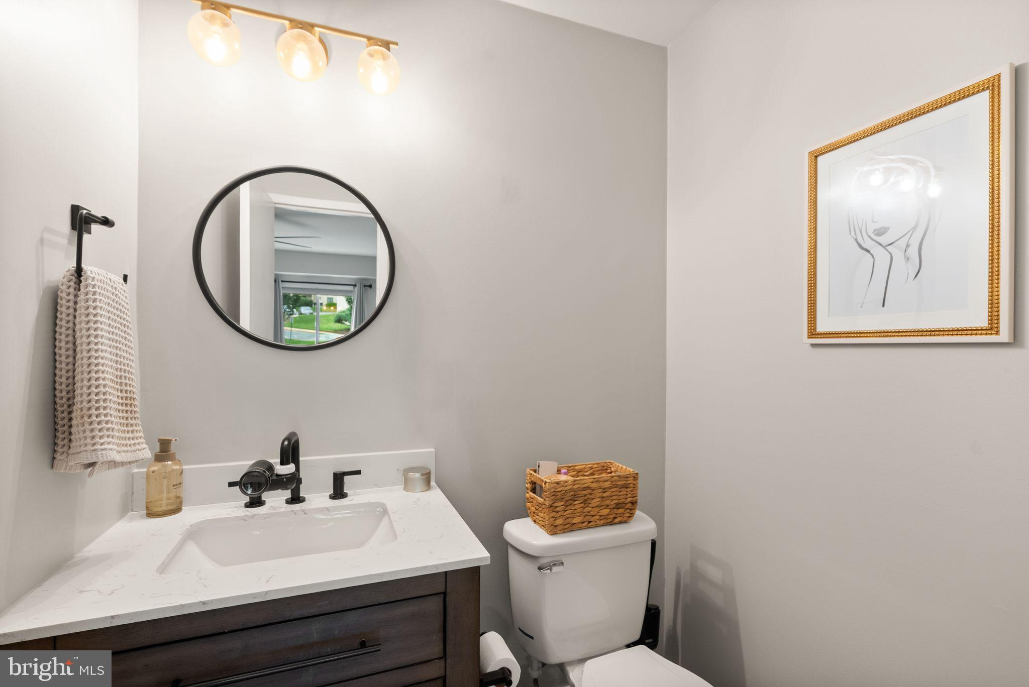 6137 Edsall Road, Unit L Alexandria, VA 22304 - Photo 27 of 36 a bathroom with a toilet a sink and a mirror