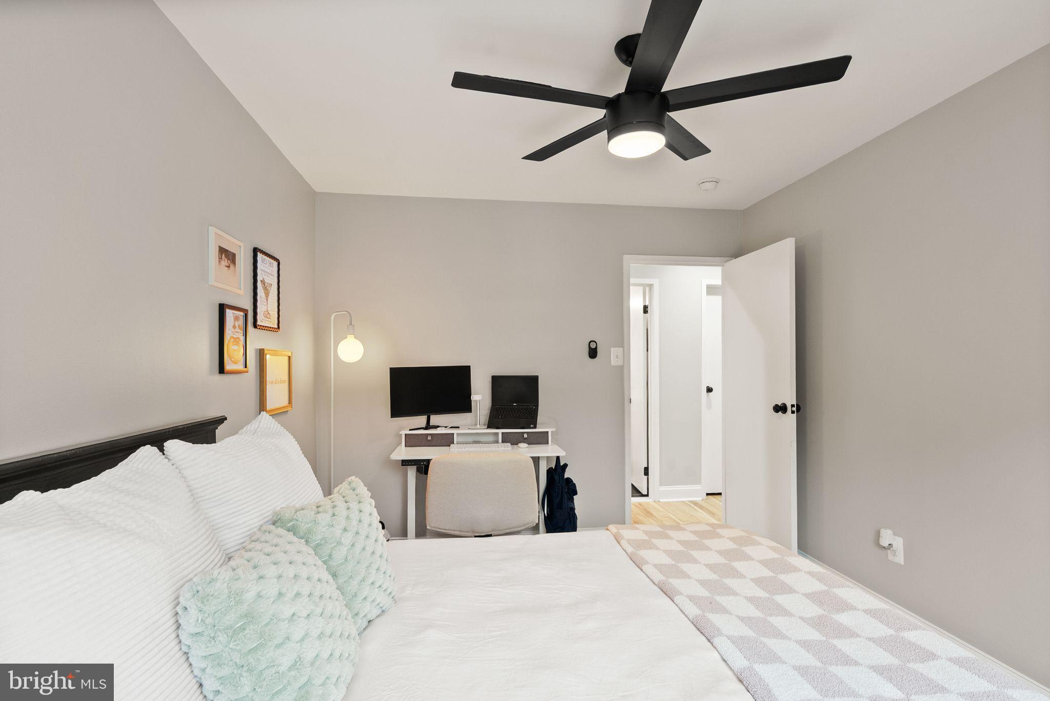 6137 Edsall Road, Unit L Alexandria, VA 22304 - Photo 31 of 36 a bedroom with a bed flat screen tv and a window