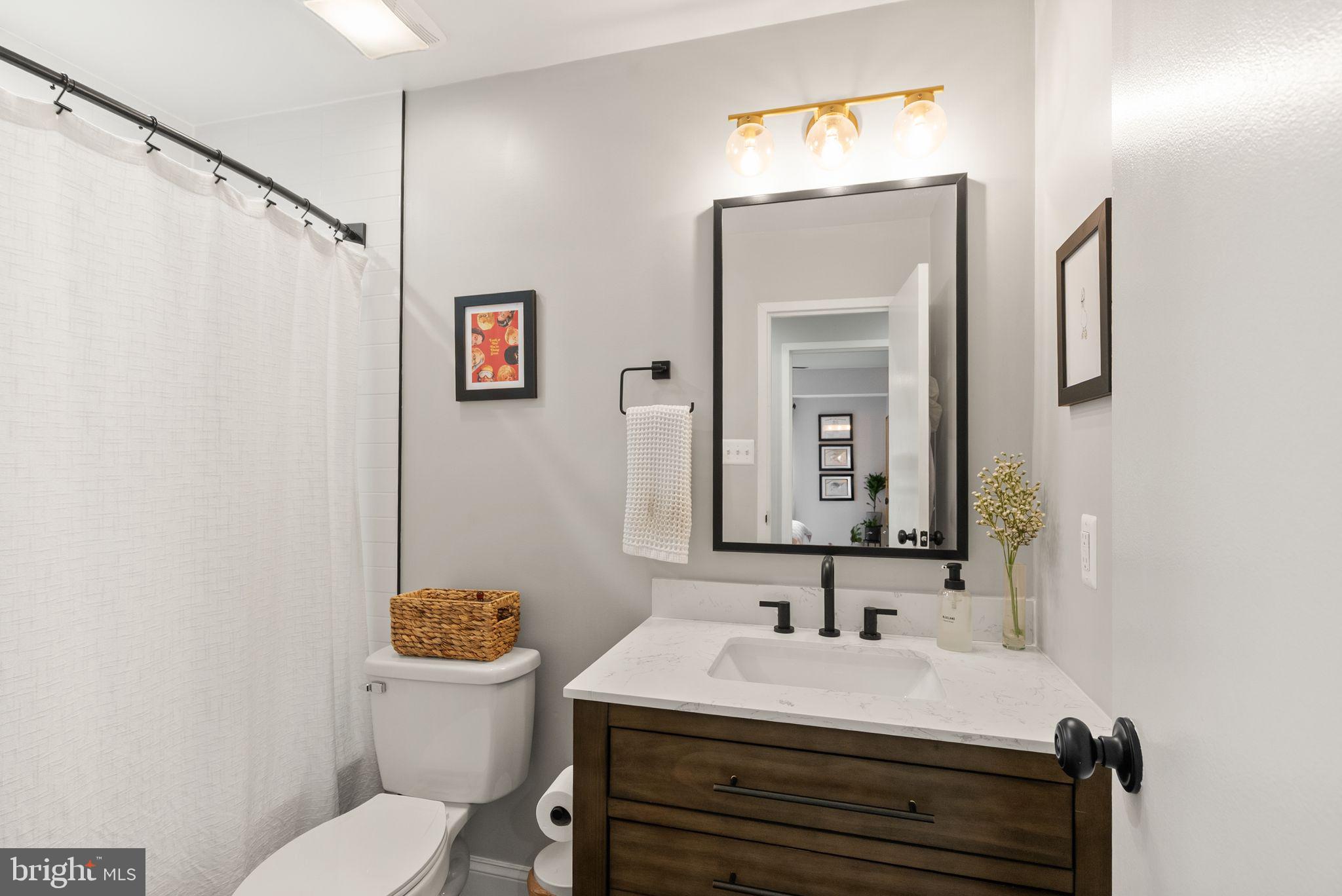 6137 Edsall Road, Unit L Alexandria, VA 22304 - Photo 32 of 36 a bathroom with a sink vanity mirror and toilet